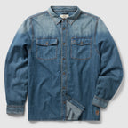 Denim Work Shirt in blue denim with long sleeves, button front, pointed collar, contrast stitching, and two flap chest pockets displayed flat