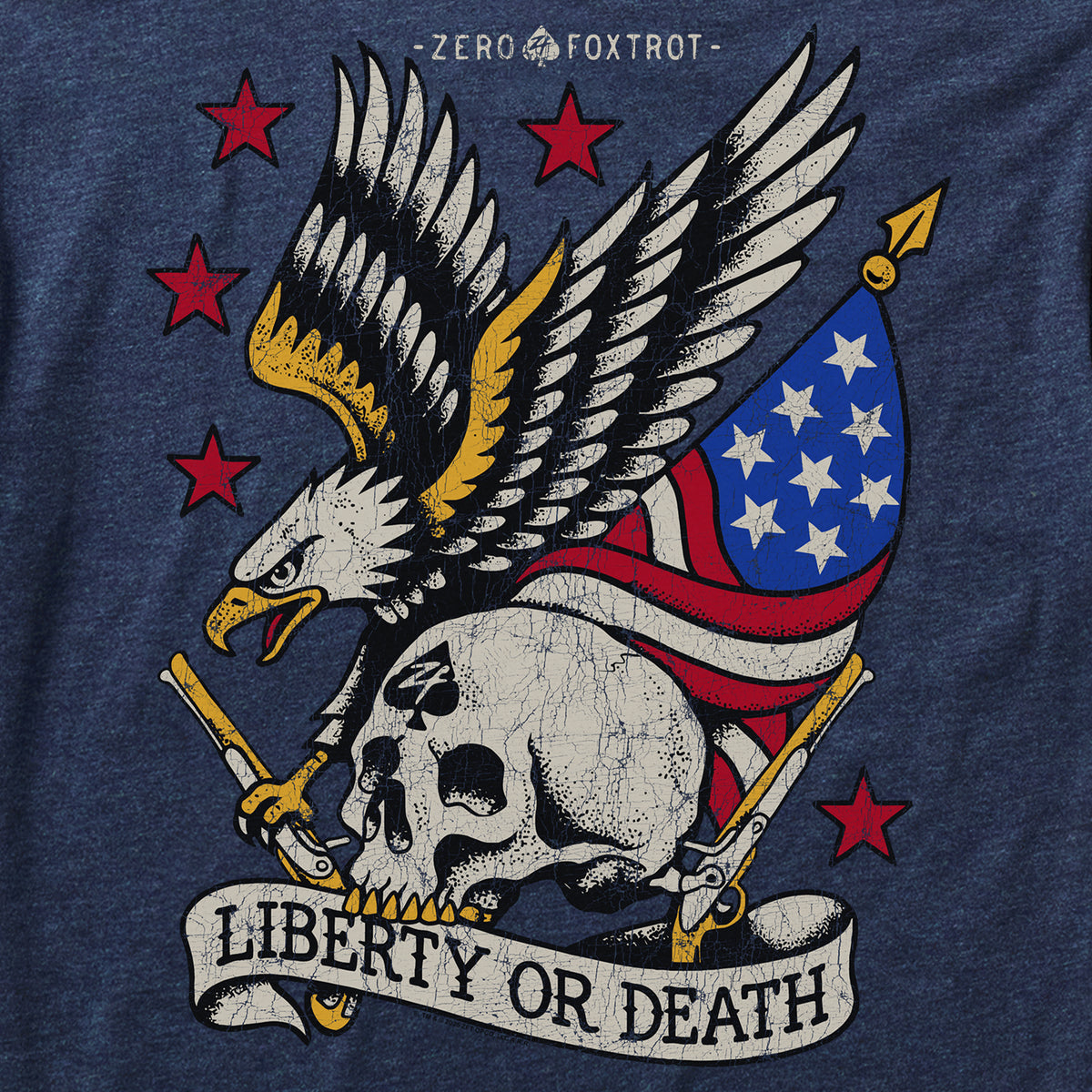Close-up of a Liberty or Death Tee showing a detailed graphic of a fierce eagle with outstretched wings holding a skull, crossed pistols, and an American flag on a dark fabric background.