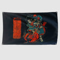 Namakubi Flag in black with vivid red and blue artwork of a Japanese warrior battling a red demon, alongside bold red lettering and illustrations