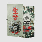 Two Microfiber Beach Towels displayed side by side, one featuring a vibrant Japanese warrior design with red kanji characters and the other a skull with an ace of spades symbol on a green camouflage background.