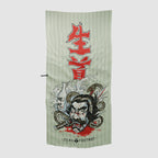 Microfiber Beach Towels featuring a detailed Japanese-inspired design with a fierce samurai head, coiled snake, sake bottle, and bold red kanji characters on a light background.