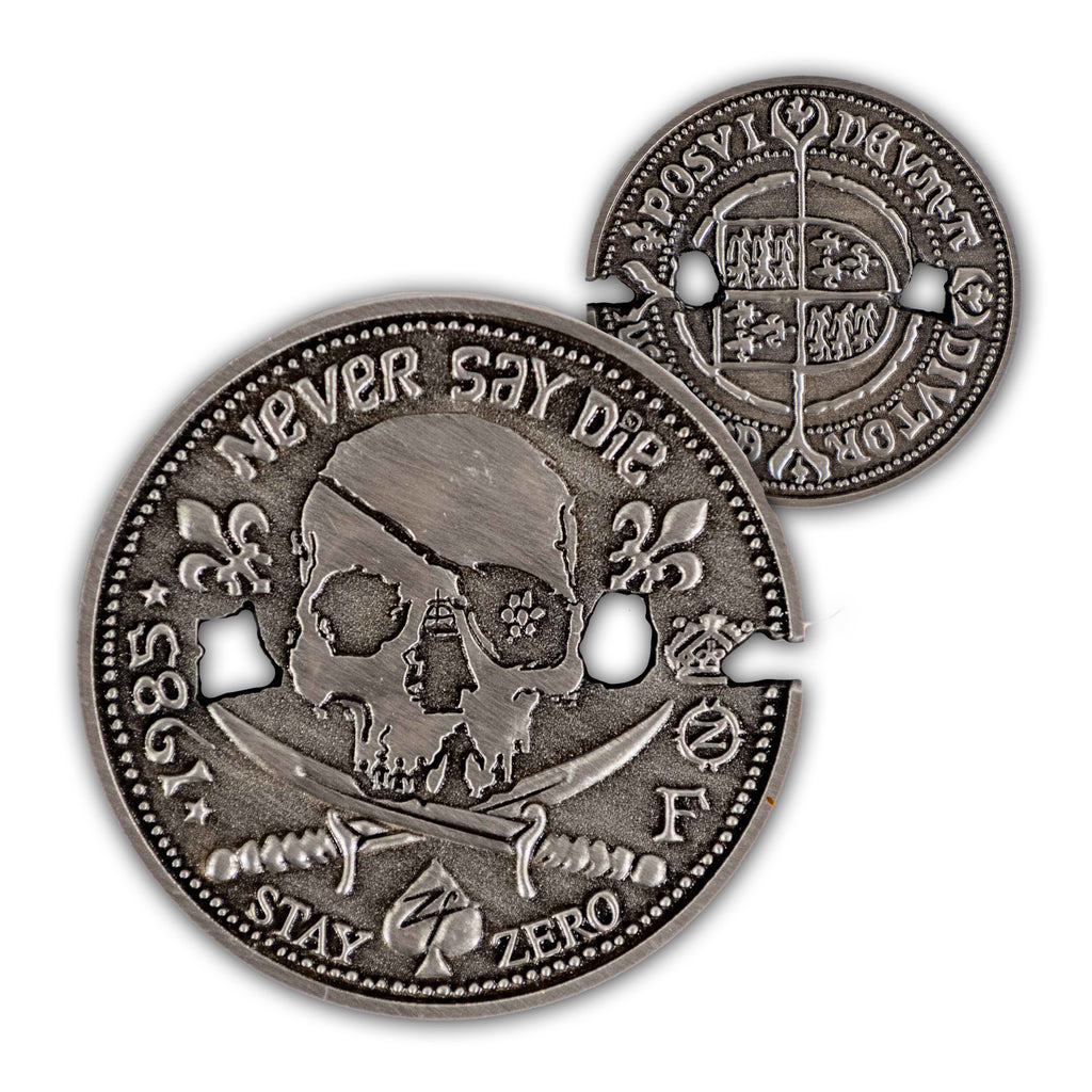 Never Say Die Coin with a distressed silver finish, skull artwork, fleur de lis details, and an ornate reverse side shown on a white background
