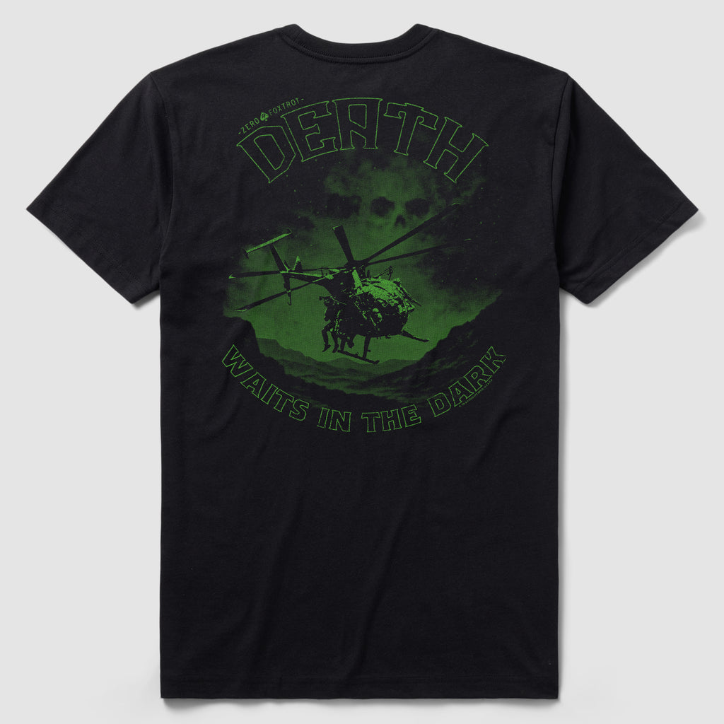 Back view of the Night Stalkers Tee featuring a dark green graphic of a helicopter flying over mountainous terrain with a skull in the background and the text "Death Waits in the Dark.