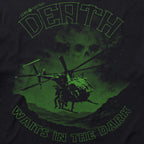 Close-up of the Night Stalkers Tee featuring a green graphic of a helicopter with soldiers and the phrase "Death waits in the dark" against a dark background.