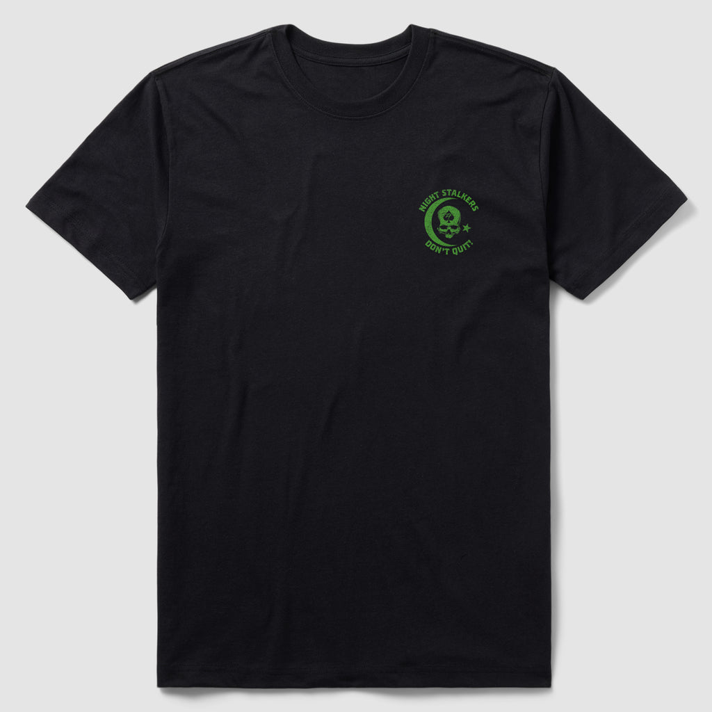 Black crew neck short sleeve t-shirt featuring a small green skull graphic on the left chest with the text "Night Stalkers Don't Quit" in a circular design, called Night Stalkers Tee.