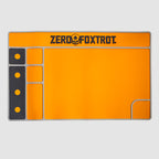Bright orange ZF Gun Cleaning Mat with black and gray accents, featuring compartments for tools and parts, and the Zero Foxtrot logo at the top center.