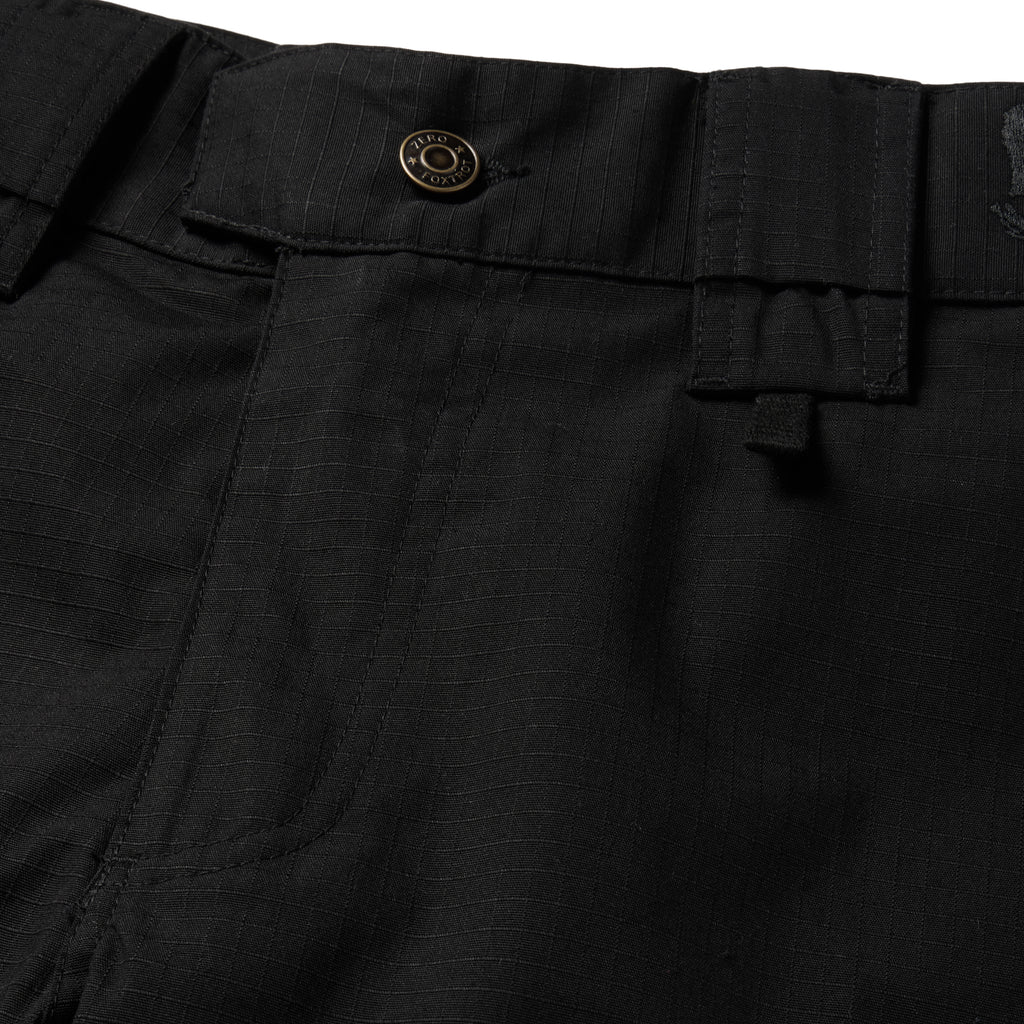 Tac Pants close up showing black fabric waistband button belt loops utility pockets and detailed stitching