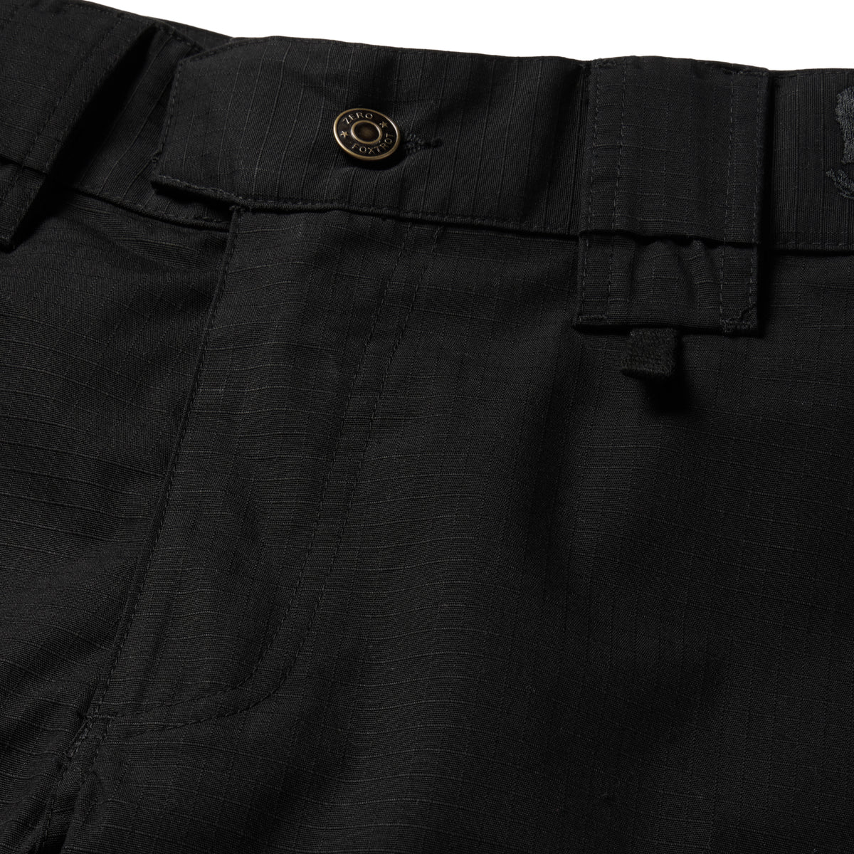 Tac Pants close up showing black fabric waistband button belt loops utility pockets and detailed stitching