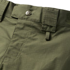 Tac Pants in olive green ripstop fabric with a buttoned waistband pocket, cargo pocket, reinforced stitching, and a utility loop close up