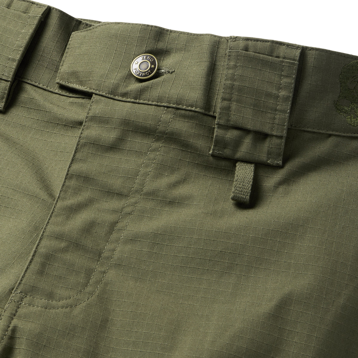 Tac Pants in olive green ripstop fabric with a buttoned waistband pocket, cargo pocket, reinforced stitching, and a utility loop close up