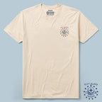 Oathbound Tee in a light beige color featuring a small navy and red skull and star design on the left chest with the text "2.1.76 Birthday" and "Zero Foxtrot" printed above and below the graphic.
