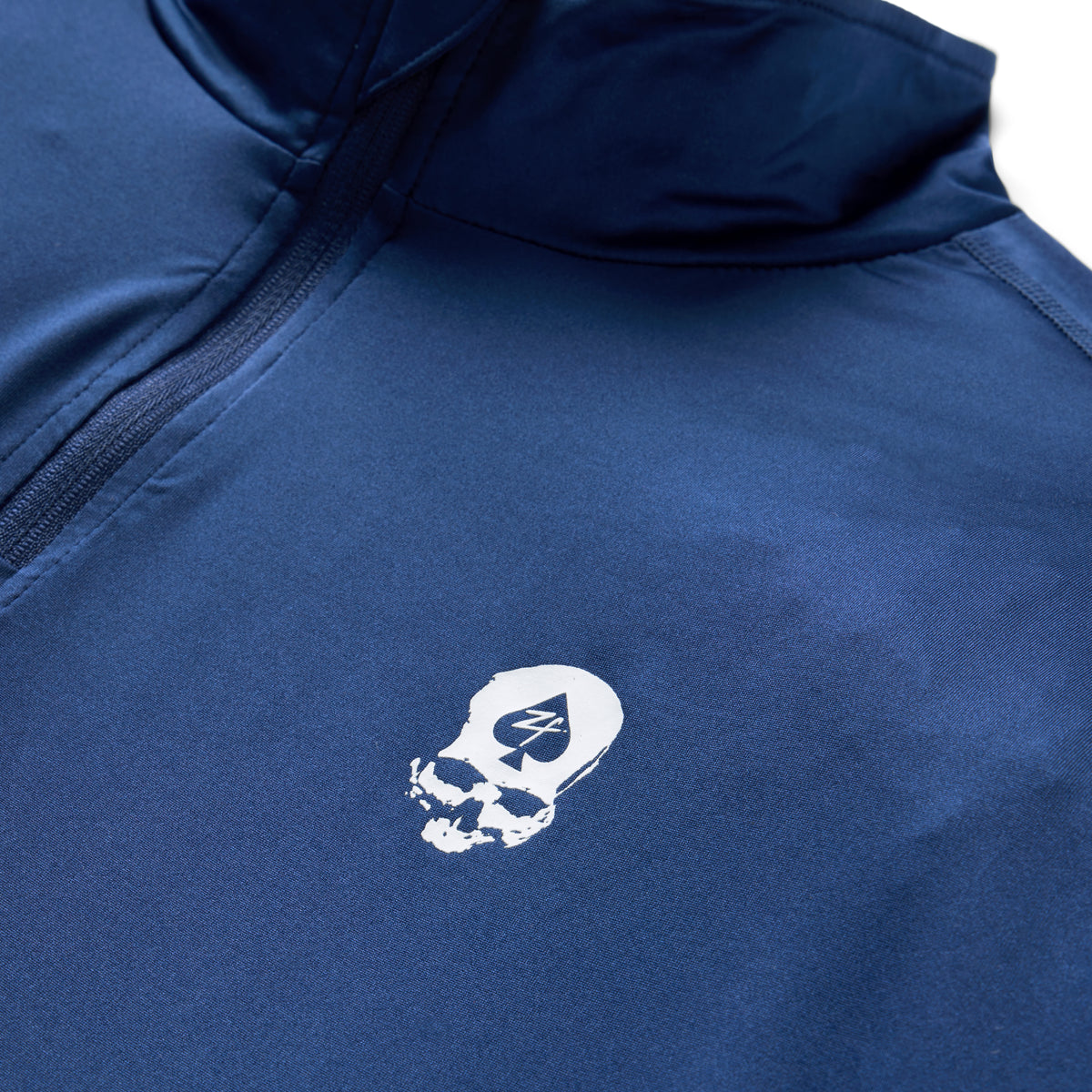 PT 1/4 Zip Long Sleeve (Last Chance), close-up of navy fabric with a quarter zip collar and white skull logo on the chest