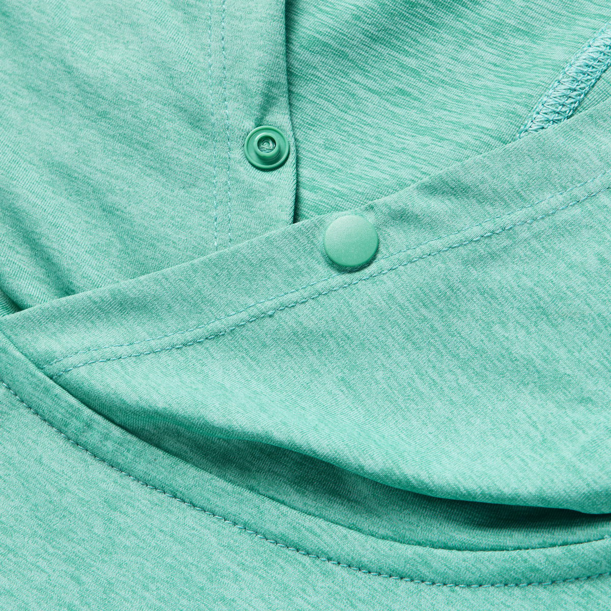 Close-up of the adjustable snap buttons and soft fabric texture in a blue-green shade on the Performance Sun Hoodie, highlighting its lightweight and breathable material.