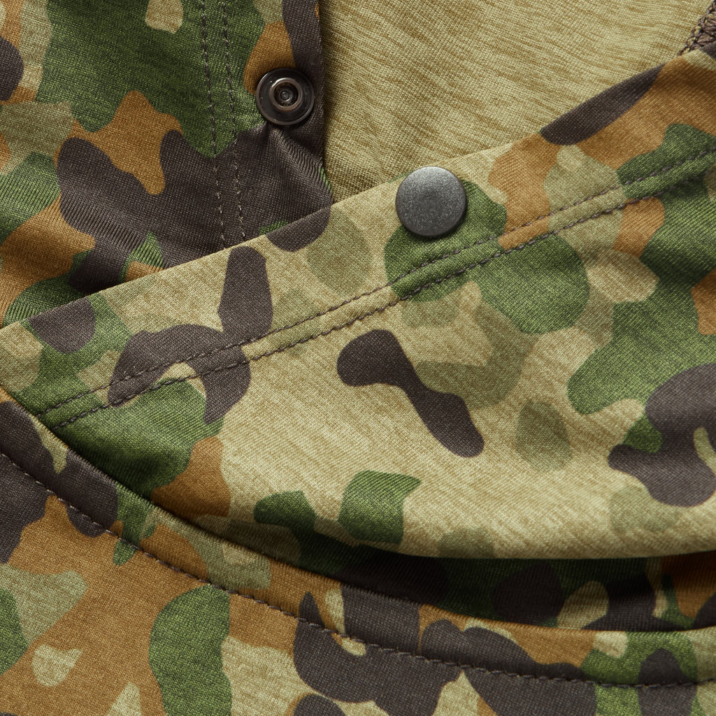 Close-up of camouflage-pattern fabric with snap buttons on the Performance Sun Hoodie, highlighting detailed stitching and durable material.