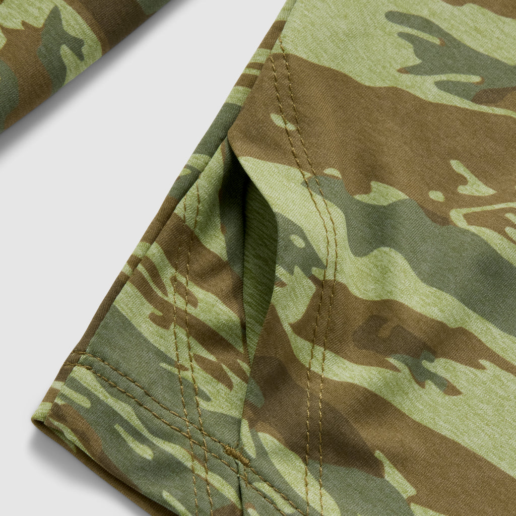 Close-up of a green and brown camouflage fabric pocket detail on the Performance Sun Hoodie, highlighting the durable stitching and texture of the material.