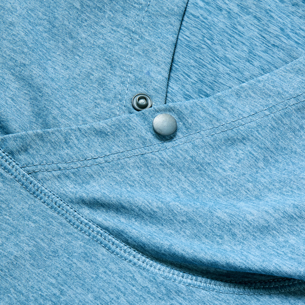 Close-up of ocean blue fabric with detailed stitching and snap button closure on the Performance Sun Hoodie, highlighting its smooth texture and quality craftsmanship.