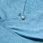 Close-up of ocean blue fabric with detailed stitching and snap button closure on the Performance Sun Hoodie, highlighting its smooth texture and quality craftsmanship.