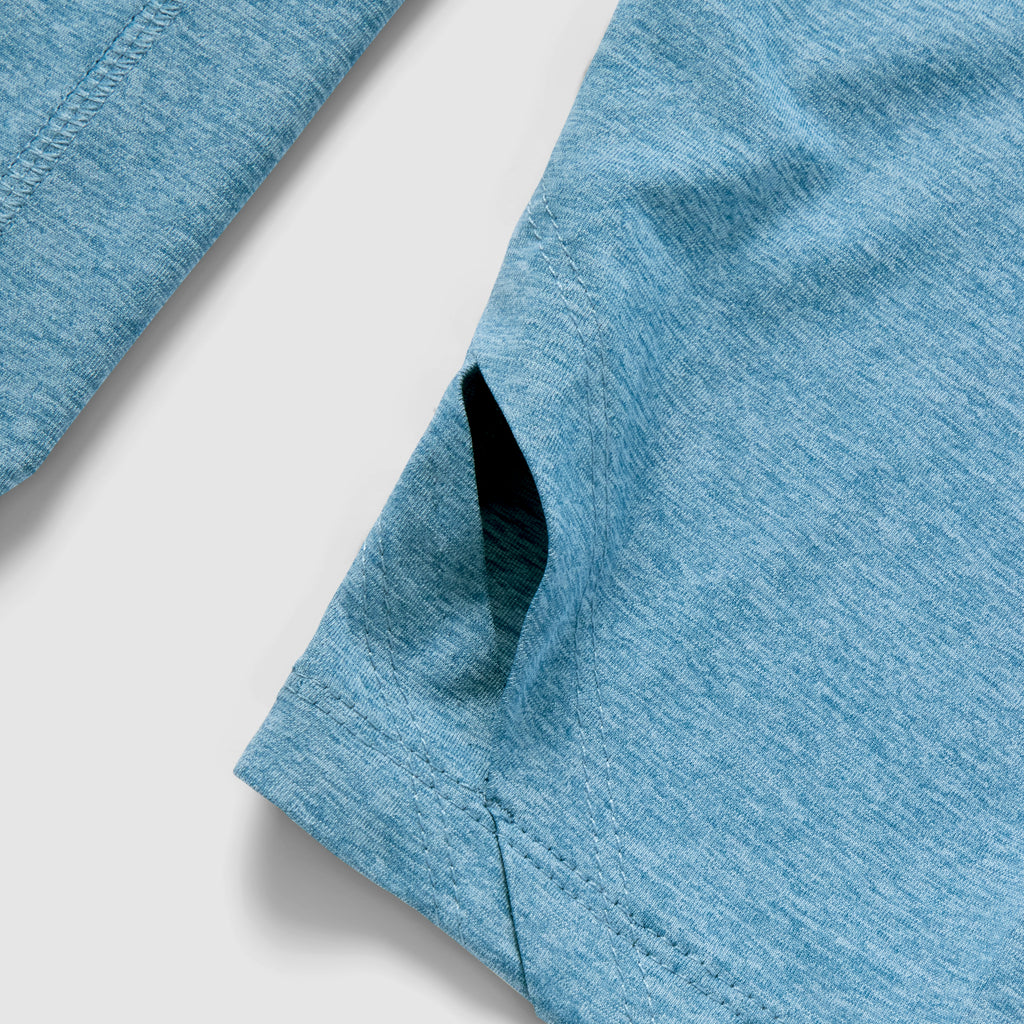 Close-up view of the side pocket and fabric texture of the Performance Sun Hoodie in ocean blue, showcasing its lightweight and breathable material.