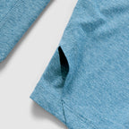 Close-up view of the side pocket and fabric texture of the Performance Sun Hoodie in ocean blue, showcasing its lightweight and breathable material.