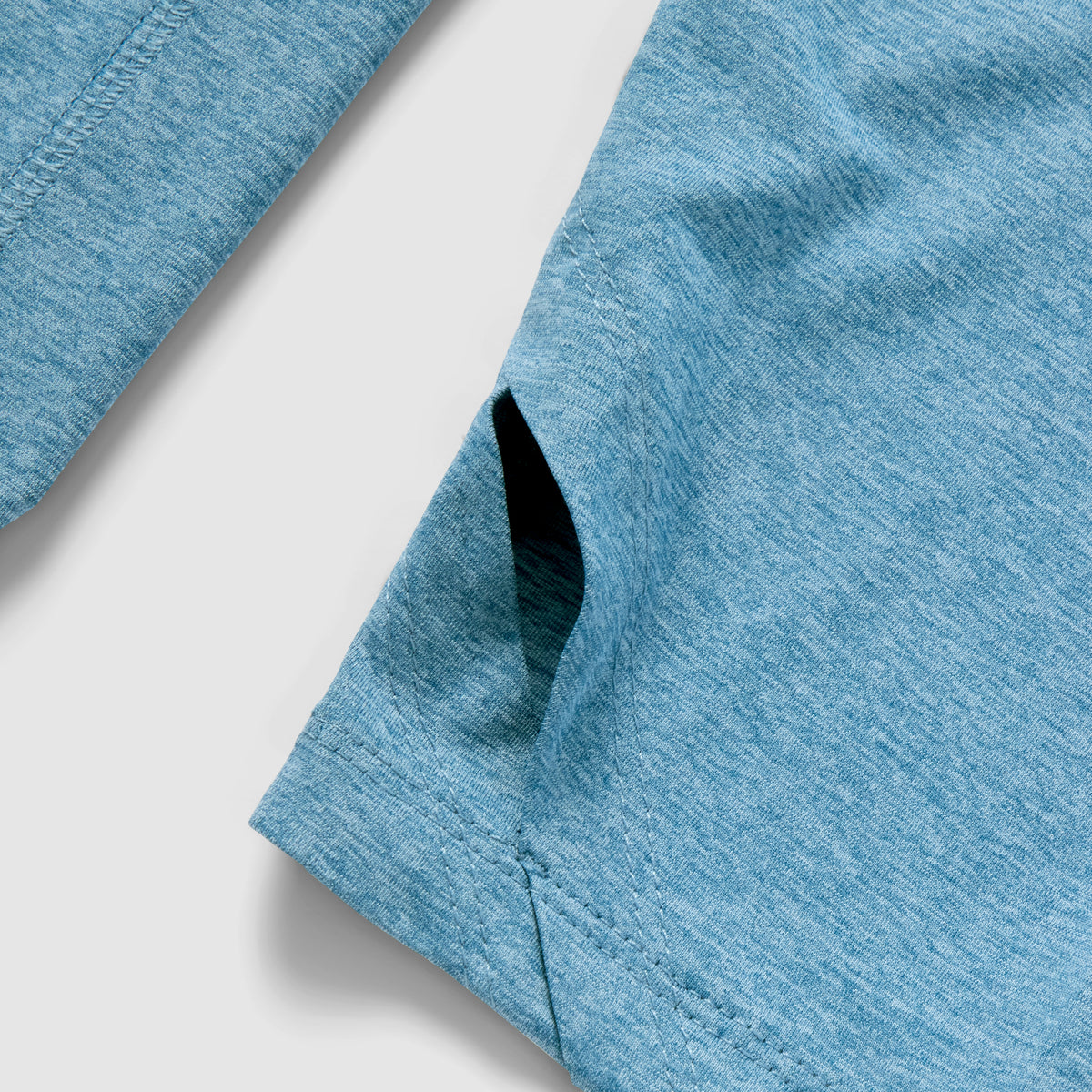 Close-up view of the side pocket and fabric texture of the Performance Sun Hoodie in ocean blue, showcasing its lightweight and breathable material.