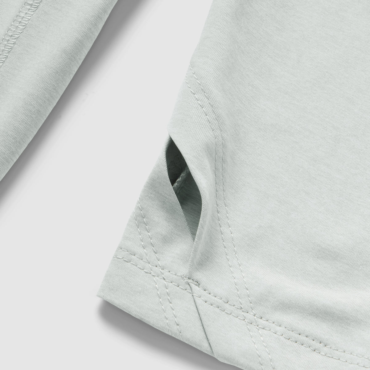 Close-up detail of a light gray fabric seam and vent on the Performance Sun Hoodie, showcasing the smooth material and reinforced stitching.