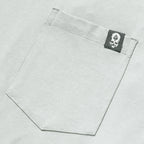 Close-up of a light gray fabric pocket with a small black and white skull logo tag on a Performance Sun Hoodie.