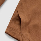 Close-up view of the brown fabric and detailed stitching on the sleeve seam of the Performance Sun Hoodie.