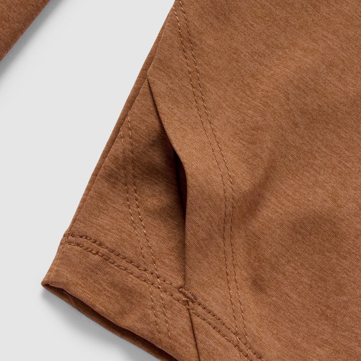 Close-up view of the brown fabric and detailed stitching on the sleeve seam of the Performance Sun Hoodie.