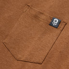 Close-up view of a rust-colored pocket detail with a small black tag on the edge, featuring the Performance Sun Hoodie.