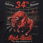 Close-up of a bold graphic on the Red Bull Attack Tee featuring a red charging bull, vintage text reading "34th Infantry Division" and "517 Days of Combat '42-'45" with an aged stadium background.