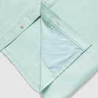 Close-up of the hem detail on a light aqua Short Sleeve F'n Soft Shirt, showing the soft fabric texture and inner pocket lining.