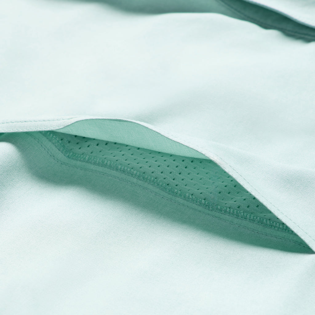 Close-up of aqua fabric showcasing the soft texture and breathable perforated lining of the Short Sleeve F'n Soft Shirt.