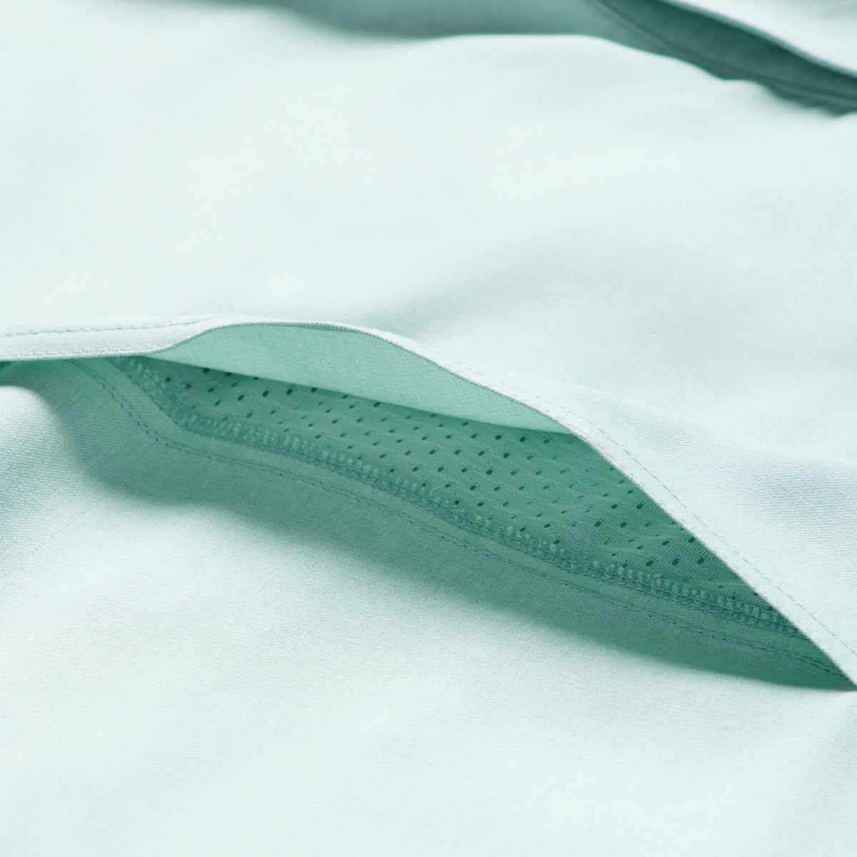 Close-up of aqua fabric showcasing the soft texture and breathable perforated lining of the Short Sleeve F'n Soft Shirt.
