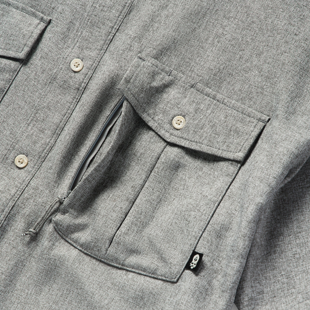 Close-up of the chest area of the Short Sleeve F'n Soft Shirt in charcoal, highlighting the buttoned flap pockets and soft textured fabric.