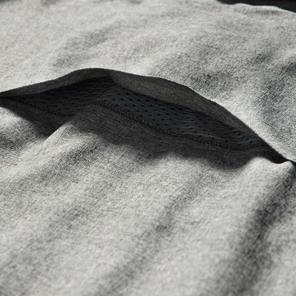 Close-up of a charcoal fabric detail with a breathable mesh layer underneath, showcasing the soft texture of the Short Sleeve F'n Soft Shirt.