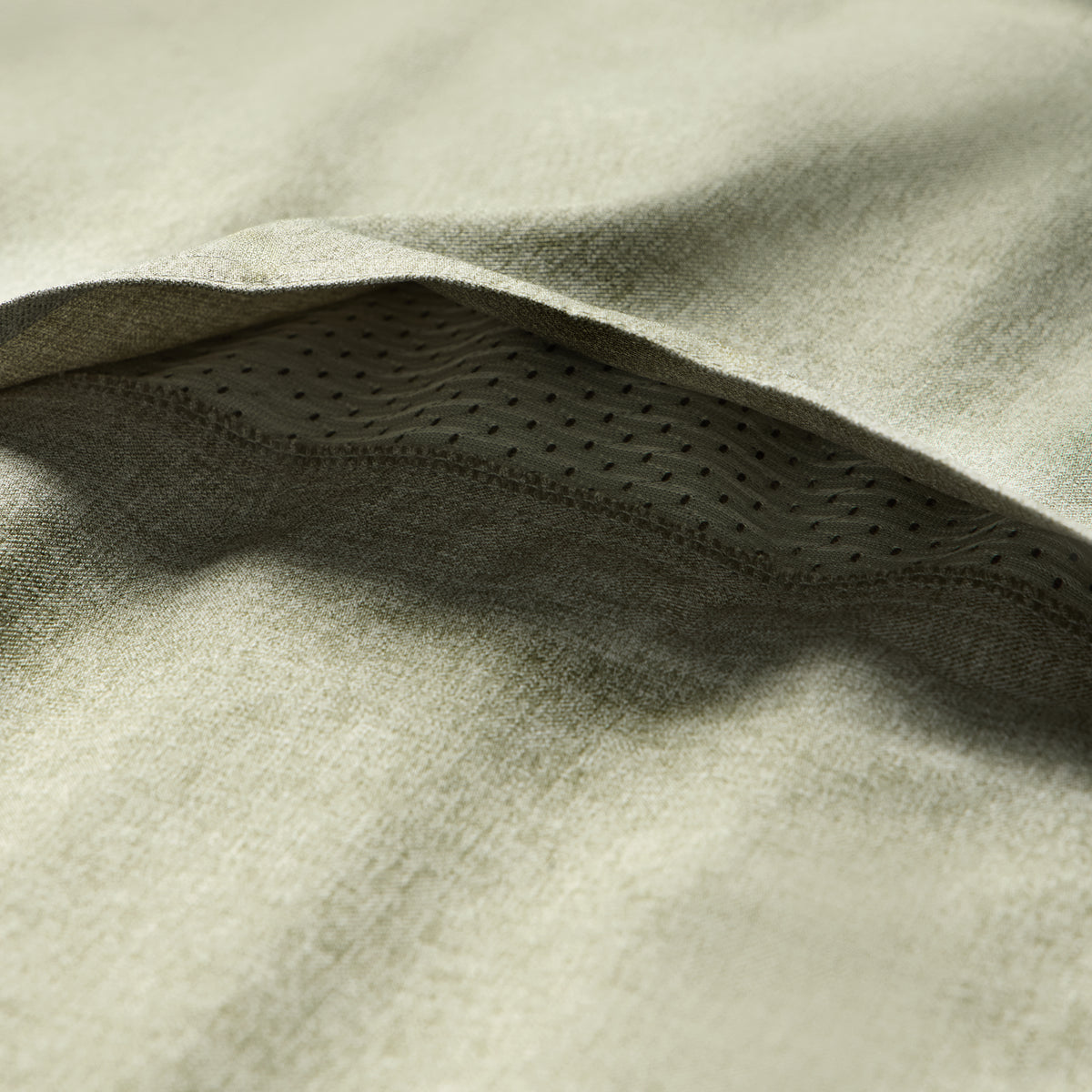 Close-up of sage green fabric texture and breathable mesh detail on the Short Sleeve F'n Soft Shirt, highlighting softness and ventilation features.