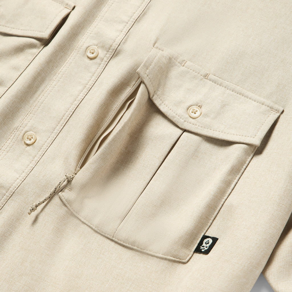 Close-up of tan fabric and detailed front pockets with button closures on the Short Sleeve F'n Soft Shirt, highlighting its soft texture and sturdy design.