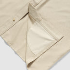 Close-up of the tan Short Sleeve F'n Soft Shirt showing detailed stitching and the inside hem with a neatly sewn pocket lining.