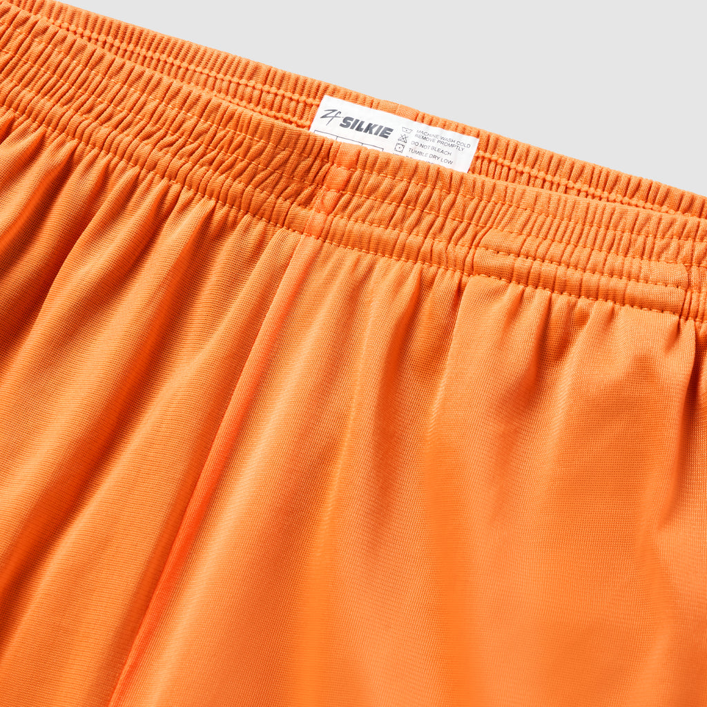 ZF Silkies - Solids in vibrant orange with a gathered elastic waistband, smooth silky fabric, and visible branded label close up