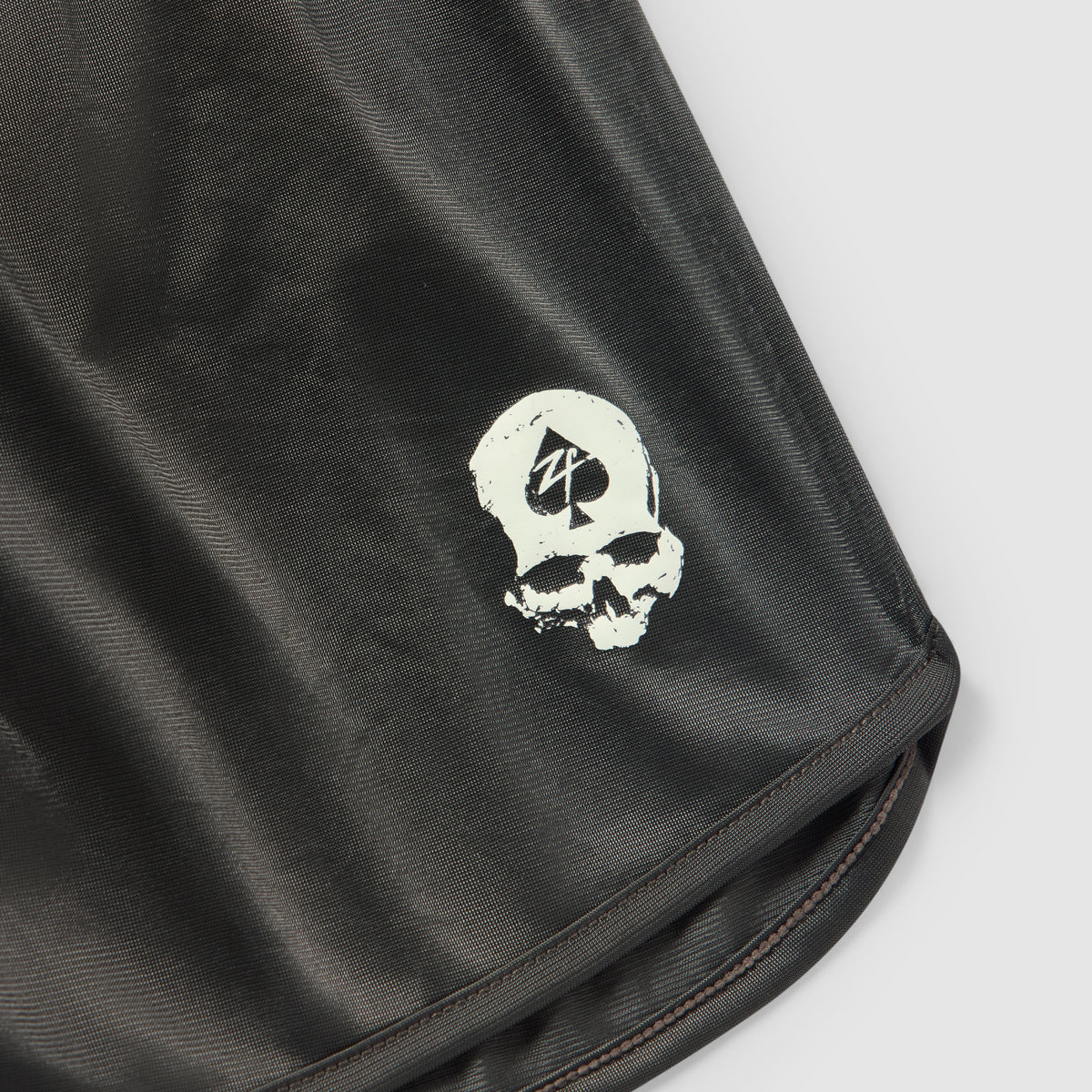 ZF Silkies - Solids black silky fabric closeup featuring a white skull graphic and neatly stitched hem edge
