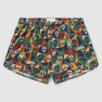 Geo Skulls Silkies featuring a colorful geometric pattern with various skull designs in shades of green, orange, navy, and beige, made from smooth fabric with an elastic waistband.