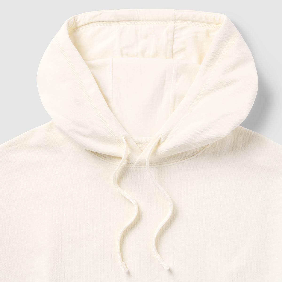 Close-up of the cream-colored hood and drawstrings of the Smuggler French Terry Muscle Hoodie made from soft, lightweight fabric.