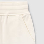 Close-up of cream-colored shorts waistband and pocket detail made from soft fabric showing texture and stitching of Smuggler French Terry Jog Shorts - 6" Inseam.