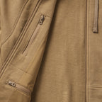 Close-up of tan fabric texture and zippered pockets detail on the Smuggler French Terry Zip Hoodie, highlighting its premium material and functional design features.