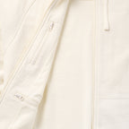 Close-up of the light-colored Smuggler French Terry Zip Hoodie showing the soft fabric texture, full front zipper, and zippered chest pocket detail.