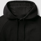 Smuggler Fleece Hoodie in black with a soft lined hood adjustable drawstrings and detailed stitching shown in close up