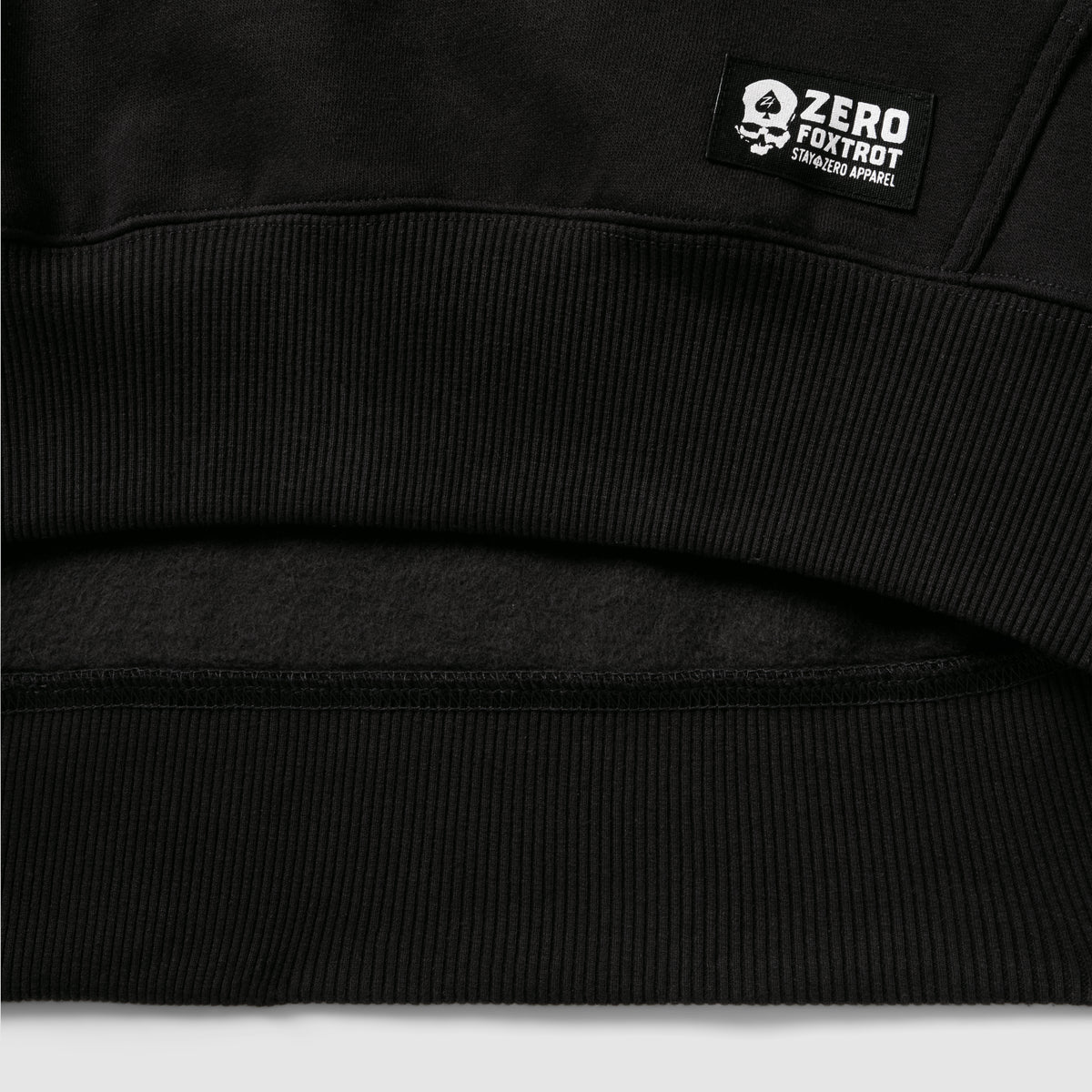 Smuggler Fleece Crew black fleece close up showing ribbed waistband and soft fleece lining