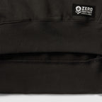 Smuggler Fleece Crew black fleece outerwear close up showing ribbed hem detailing soft interior lining and a branded label
