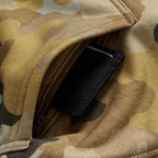 Smuggler Fleece Crew in camouflage, close up of the outerwear fabric showing a zippered pocket and black woven label