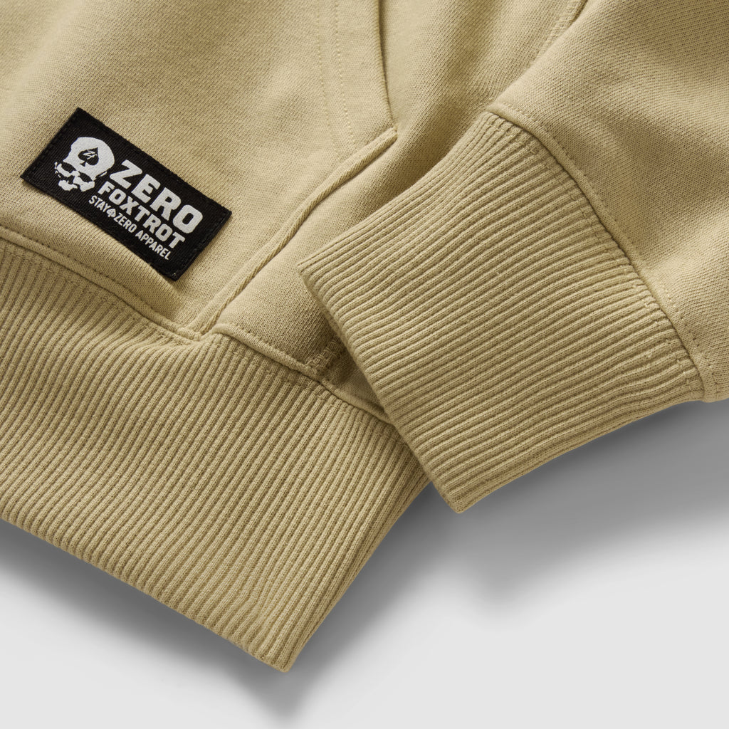 Smuggler Fleece Crew in tan fleece, shown in close up with ribbed hem and cuff details plus a black Zero Foxtrot logo patch